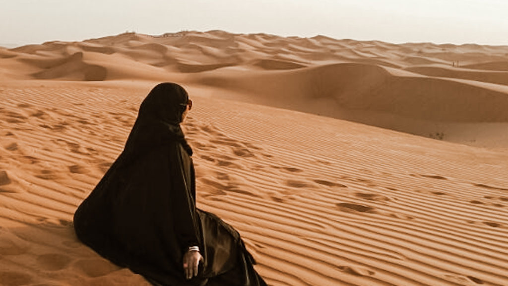 Female sitting In A Desert