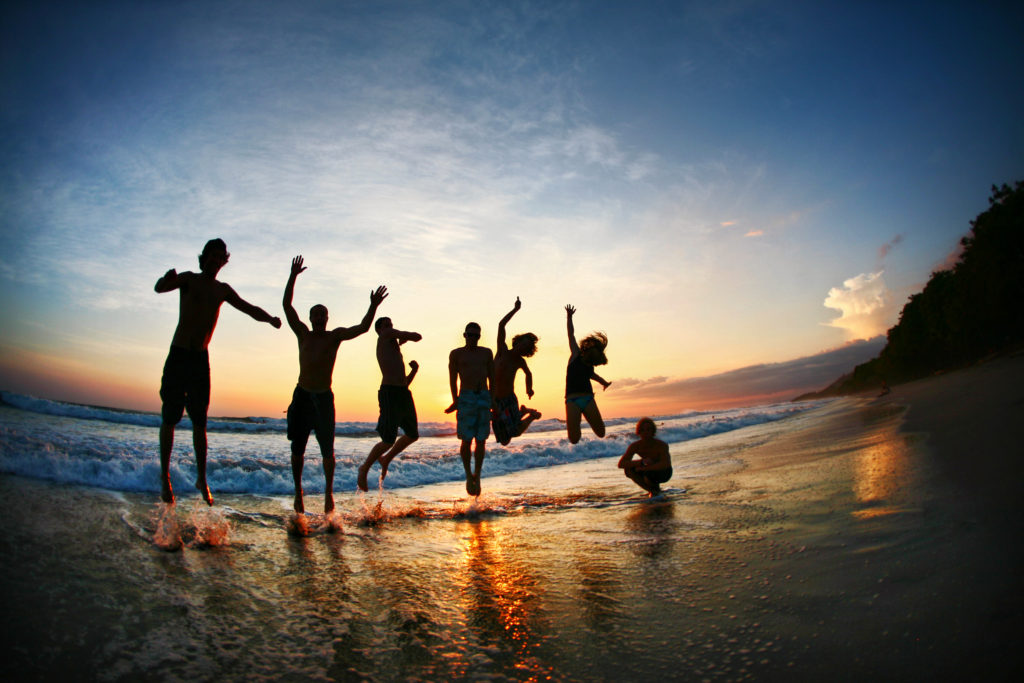 People Jumping On The Beach Pura Vida Lifestyle